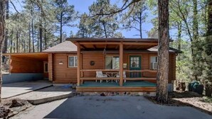 A wooden cabin with a porch, a small table, and chairs. - Cabin in the Pines, Prescott, AZ (Prescott)