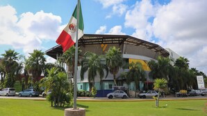 Un hotel de diseño moderno, con un amplio atrio central y un asta con la bandera nacional.