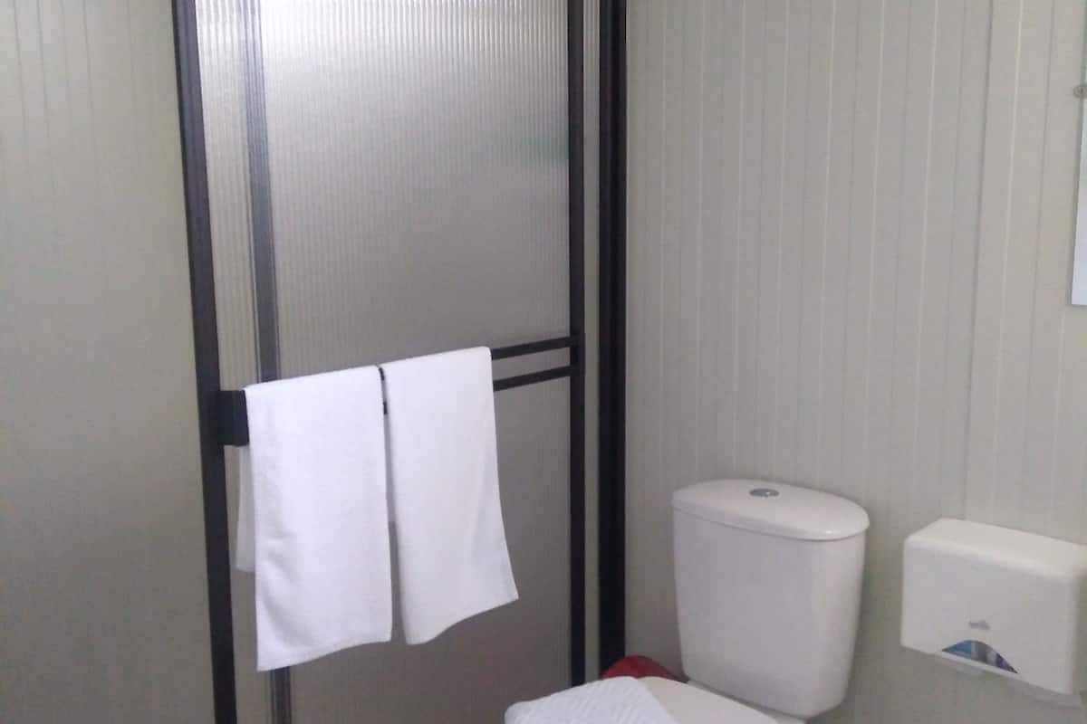 standard twin room | bathroom | shower, designer toiletries, towels, soap