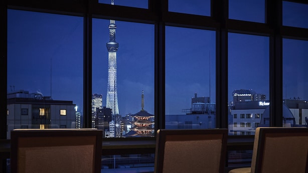 A view from a hotel room with large windows overlooking a cityscape at night, featuring a prominent tower and a pagoda. - Asakusa View Hotel Annex Rokku (Tokyo)