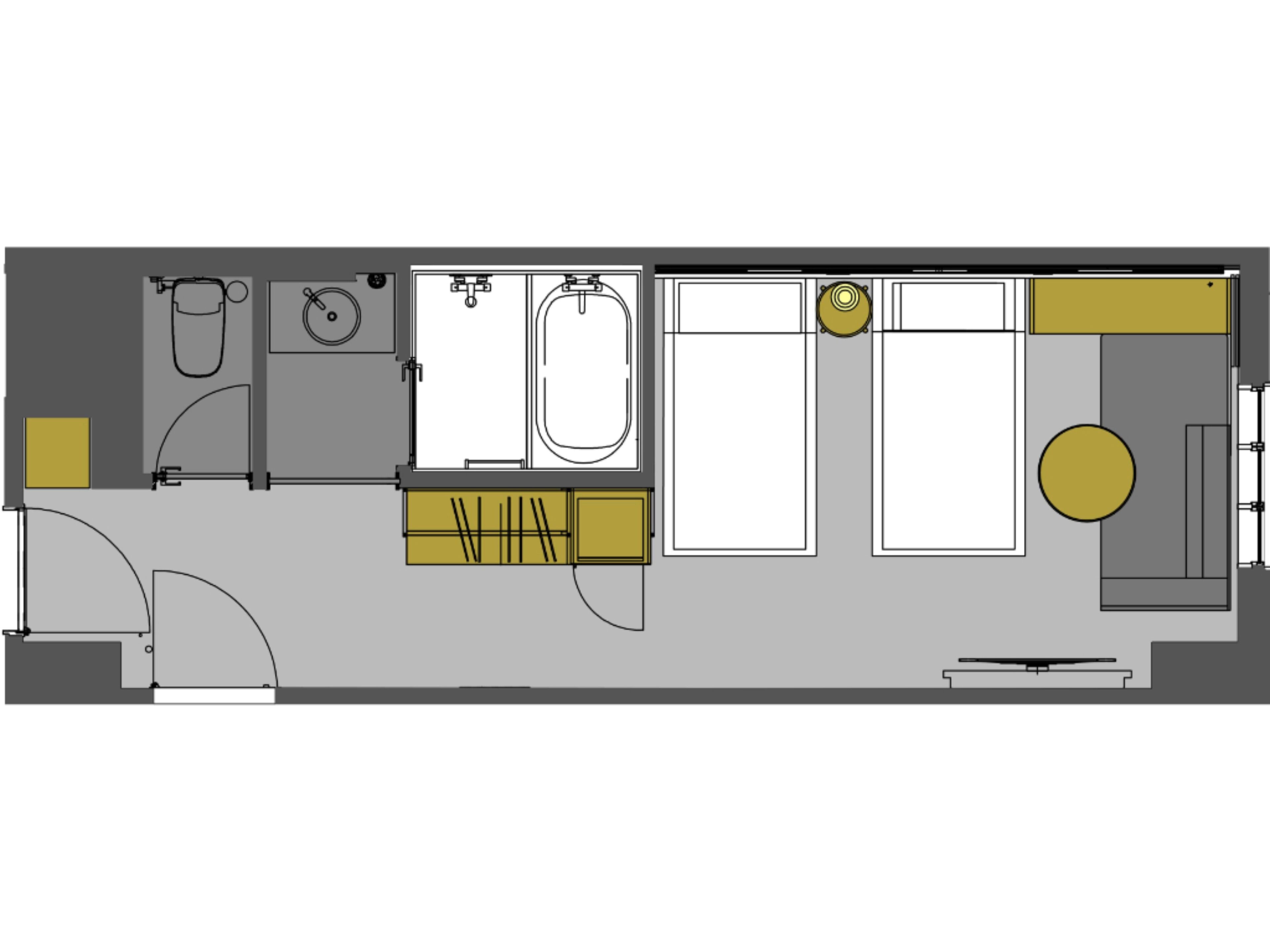 A floor plan of a hotel room with a bathroom, a small kitchenette, and a seating area.