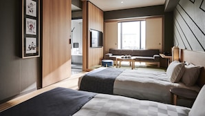 A modern hotel room with two beds, a sofa, a TV, and a large window. - Asakusa View Hotel Annex Rokku (Tokyo)