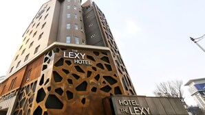 A modern building with a unique facade featuring geometric cut-outs. The building is labeled "The Lexy Hotel." - Lexy Hotel (Daejeon)