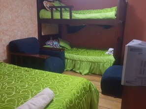 A room with bunk beds, a desk, and a television. - Bio Bamboo Bed and Breakfast (Ambato)