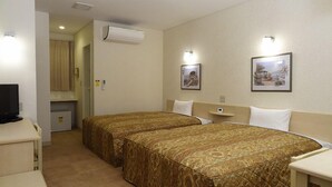 A hotel room with two beds, a TV, a mini-fridge, and a painting on the wall. - Family Lodge Hatagoya Kagoshimatarumizu (Tarumizu)