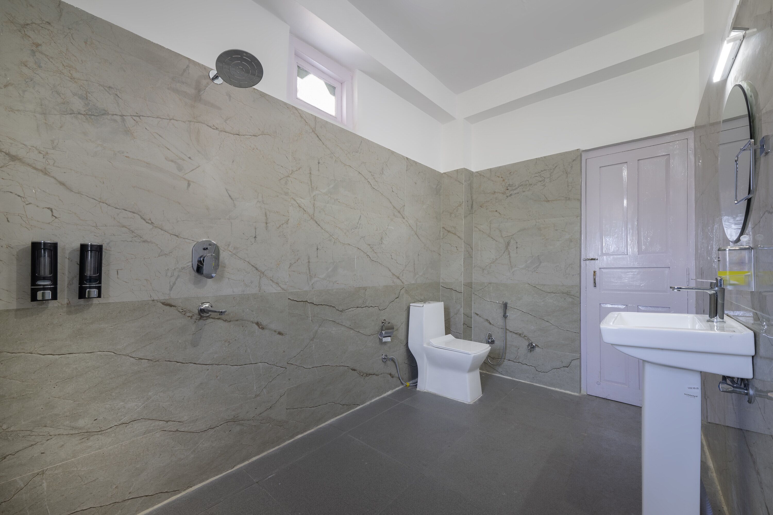 A bathroom with a toilet, sink, and shower.