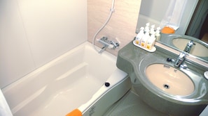 A bathroom with a bathtub, a sink, and toiletries. - Family Lodge Hatagoya Fujitsuru (Tsuru)