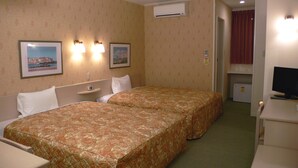 A hotel room with two beds, a small desk, a TV, and a mini-fridge. - Family Lodge Hatagoya Kanazawa Uchinada (Uchinada)