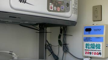 A washing machine with a control panel and a label indicating it is a Mitsubishi DR-D40Q model.