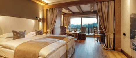 A bedroom with two beds, a balcony, and a view of the outdoors.
