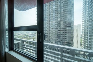 Panoramic city views from a high-rise window.