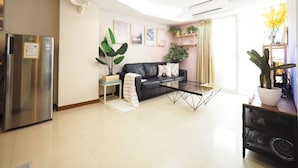 A modern living room with a sofa, coffee table, and a refrigerator. - SOGO Dept. Zhongxiao Fuxing MRT (Taipei)