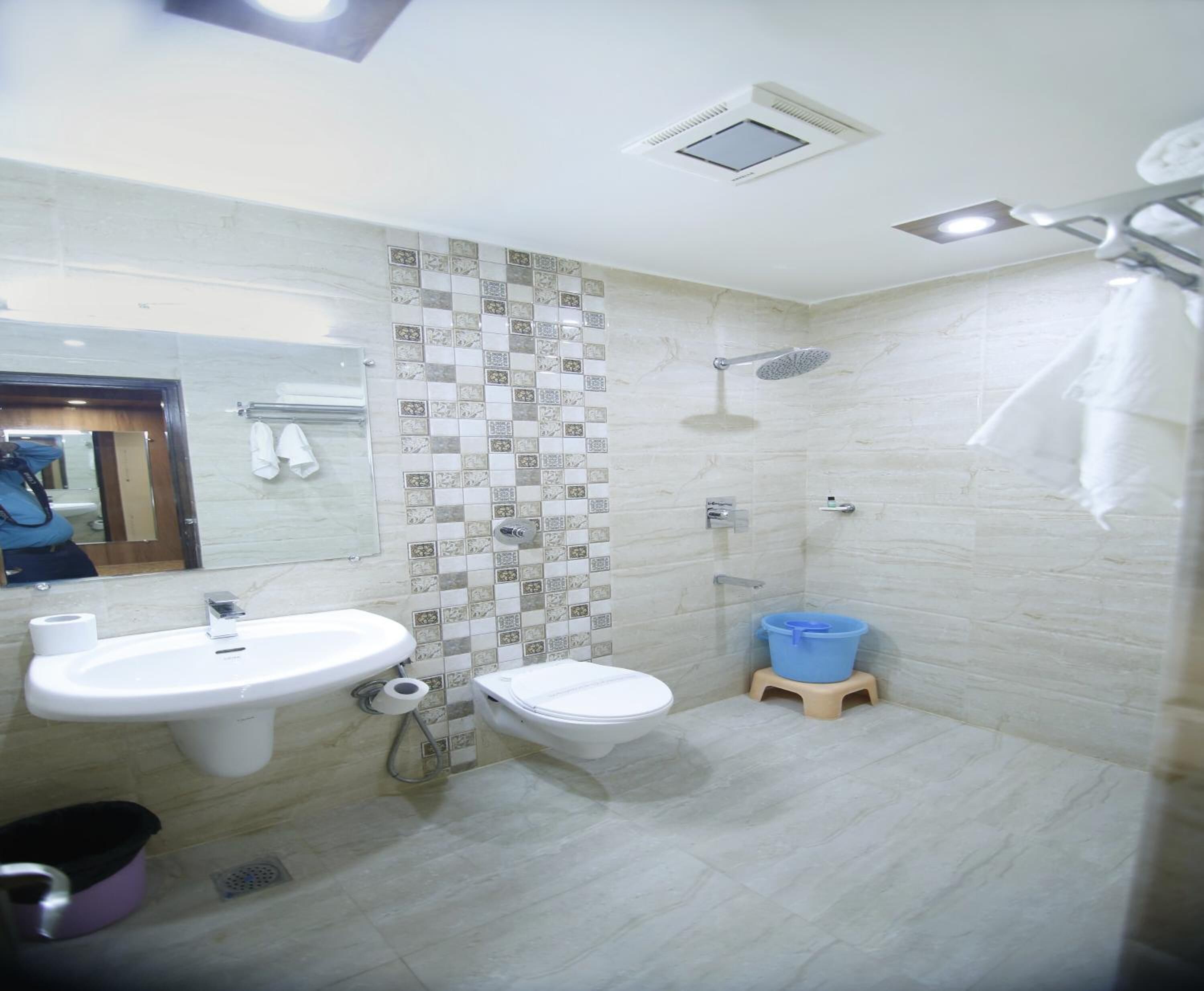 A bathroom with a sink, toilet, and shower.