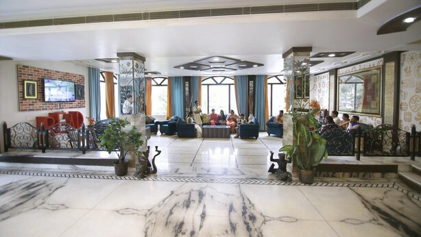 A spacious lobby with marble flooring, comfortable seating areas, and large windows allowing natural light. - Hotel Sheetal Regency (Mathura)
