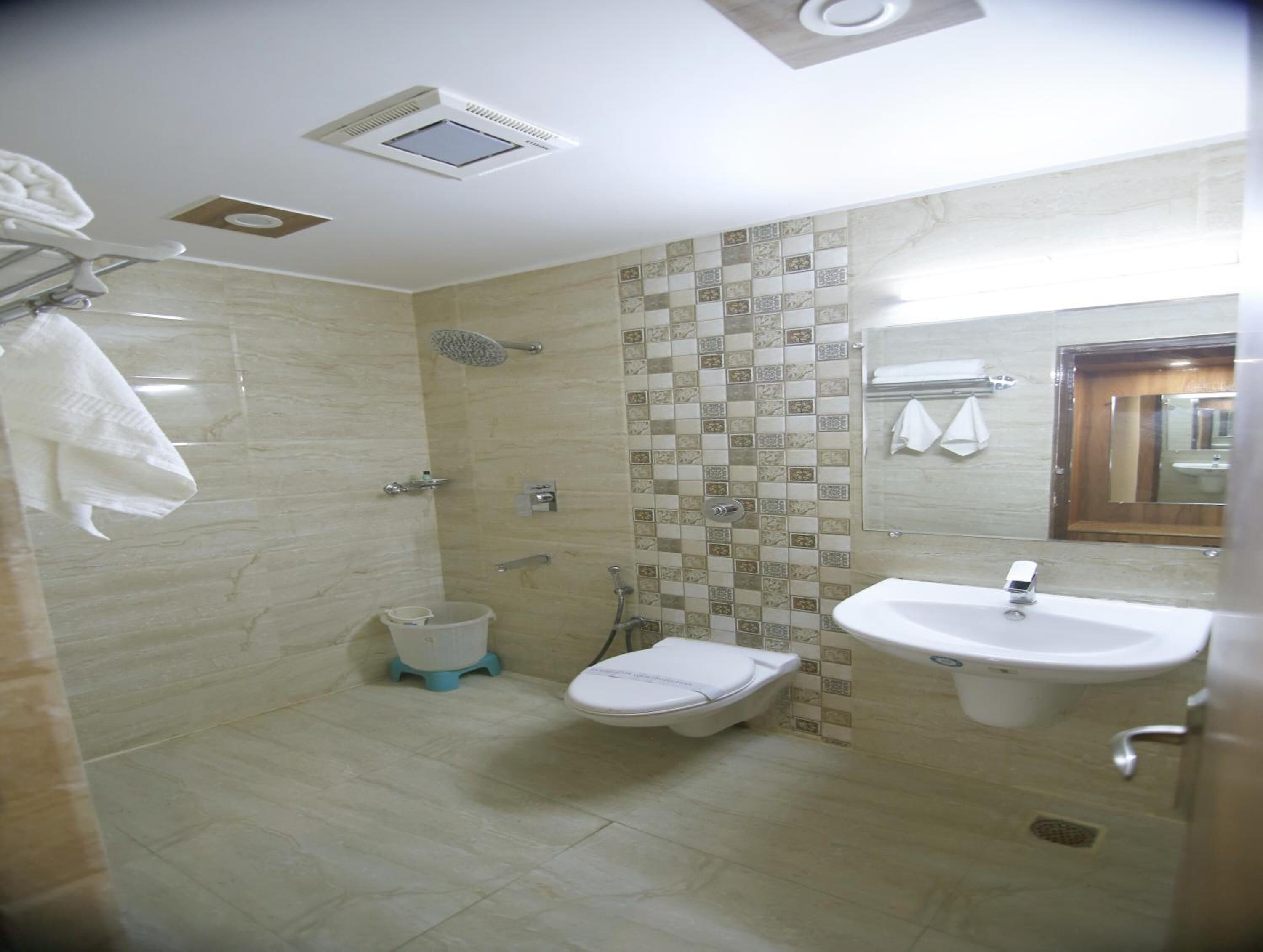 A bathroom with a shower, toilet, and sink.