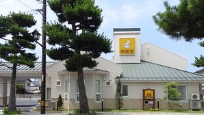 A building with a sign reading "Travel Inn." - Family Lodge Hatagoya Izumo Taisha (Izumo)