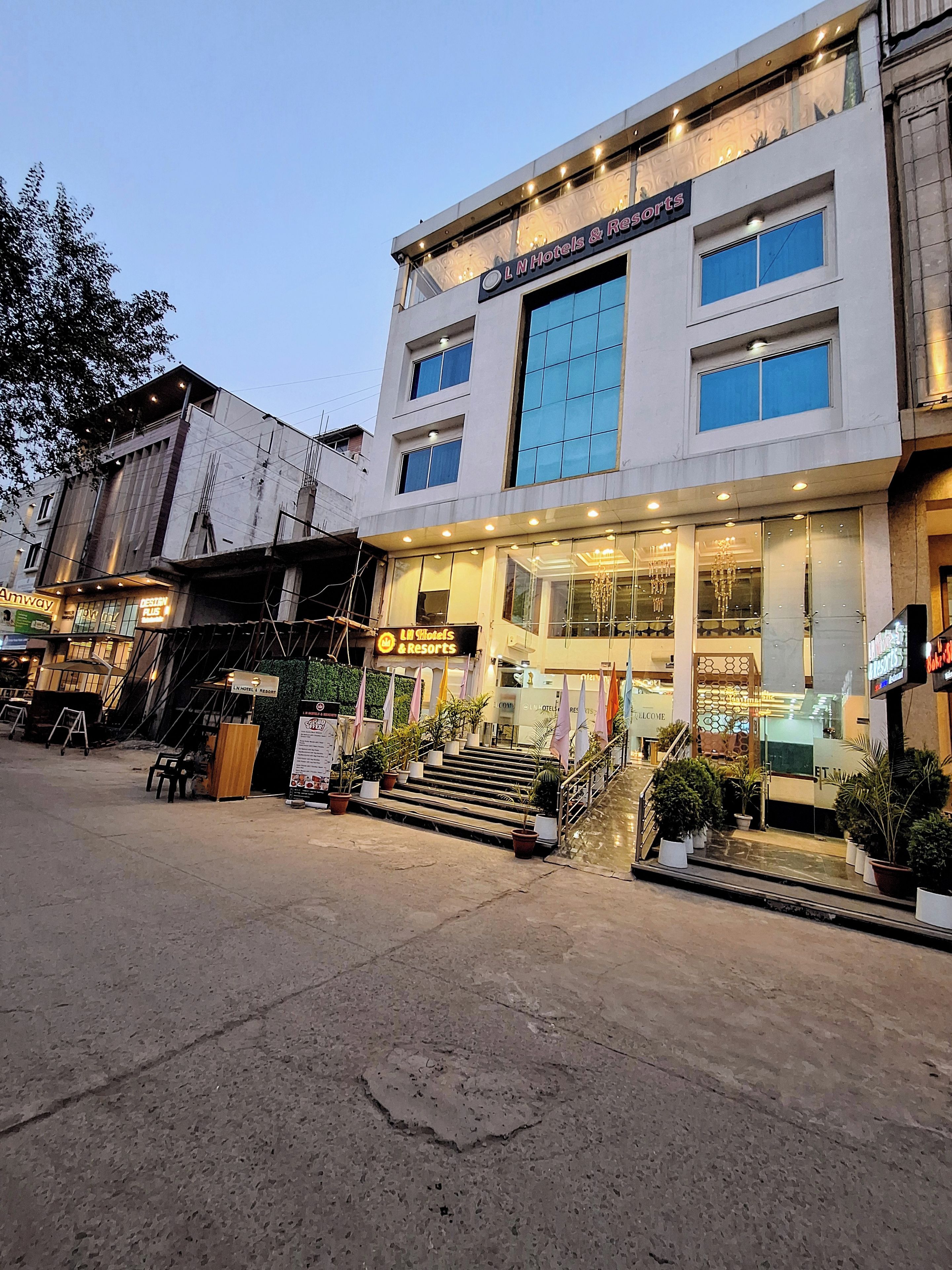 A hotel with a modern facade, multiple windows, and a well-lit entrance.