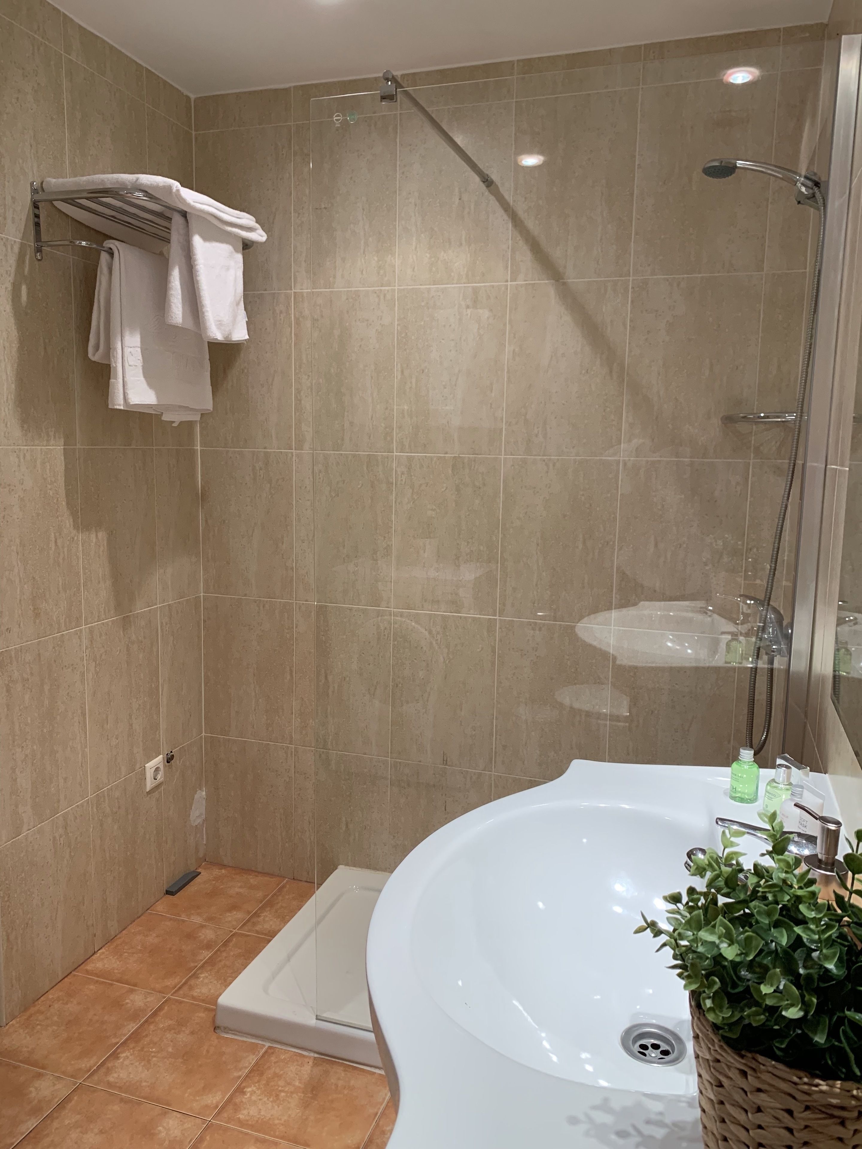 Une salle de bain moderne équipée d’une douche, d’une baignoire et d’un lavabo.