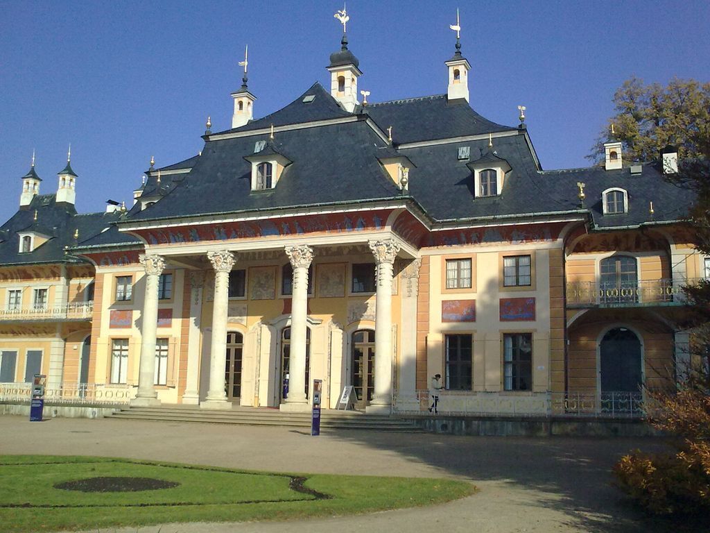 A large, historic building with a symmetrical facade, prominent columns, and a central entrance.