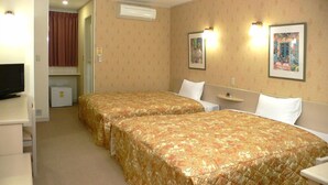 A hotel room with two single beds, a television, a small refrigerator, and a door leading to a bathroom. - Family Lodge Hatagoya Iga (Iga)
