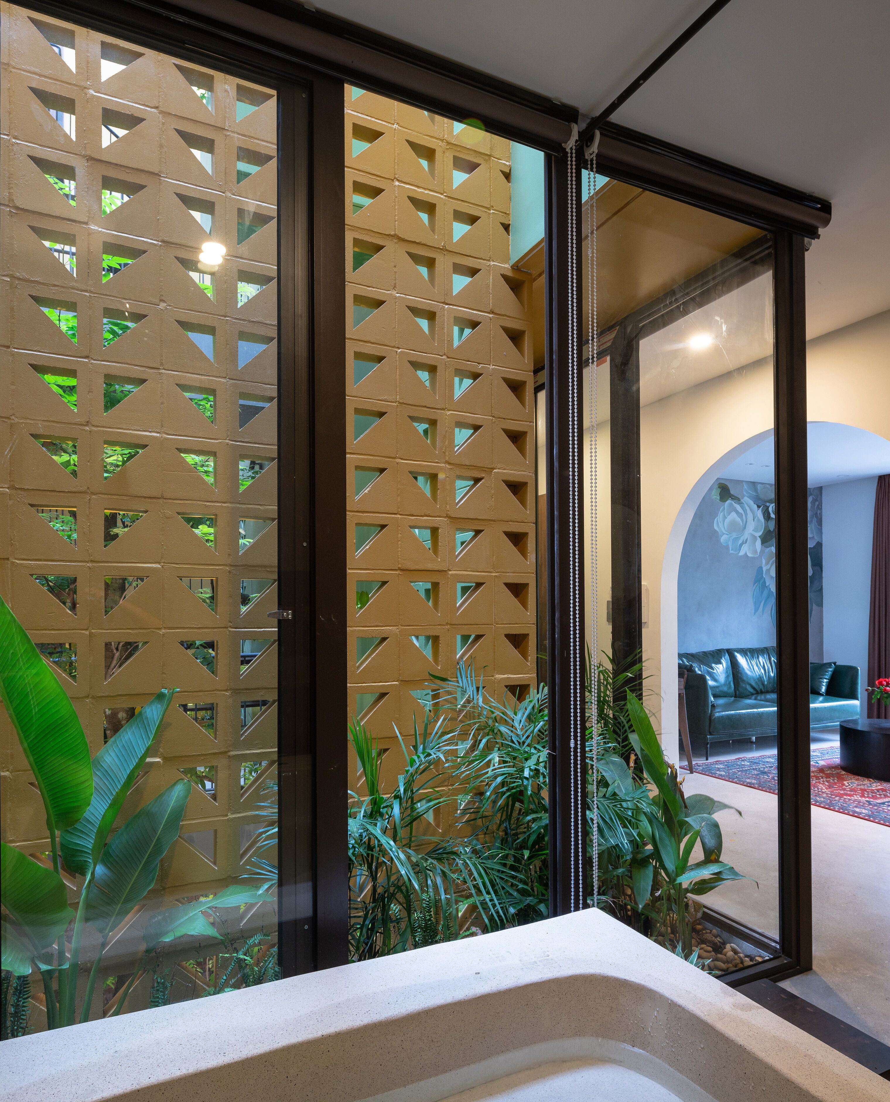A modern interior with a sliding glass door leading to a living area.