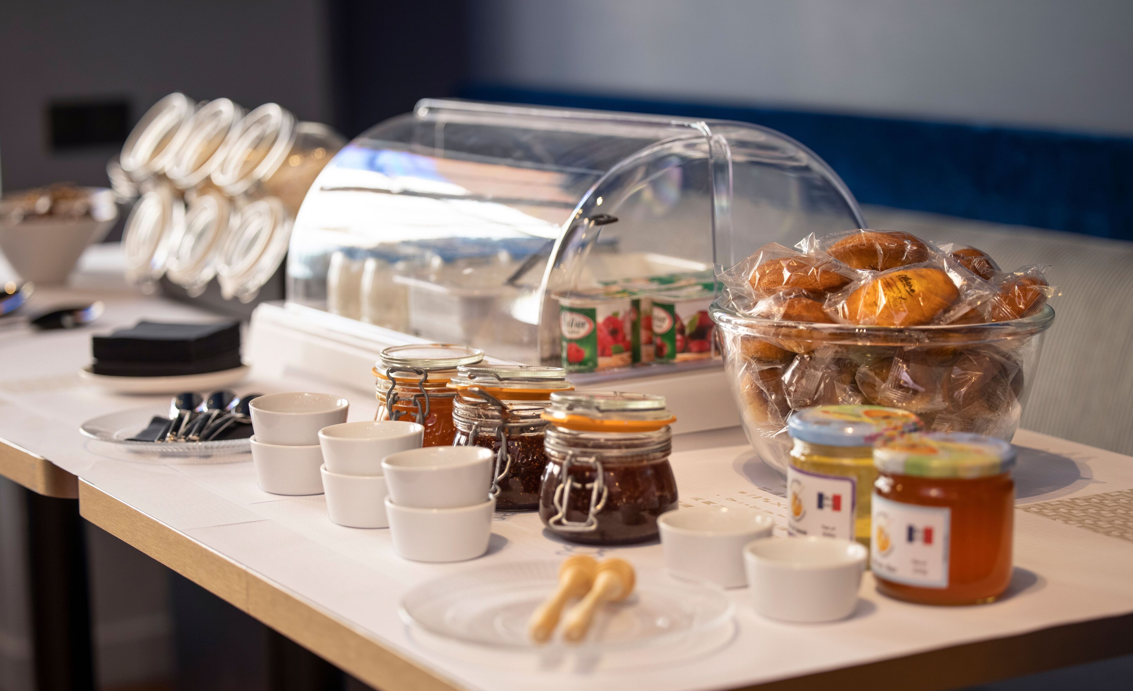 A breakfast buffet with various food items and condiments.