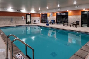 A swimming pool with a no diving sign, lounge chairs, and a tiled wall. - Holiday Inn Express & Suites The Dalles by IHG (The Dalles)