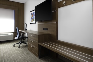 Un espacio de oficina moderno con un escritorio, una silla y televisor integrado.