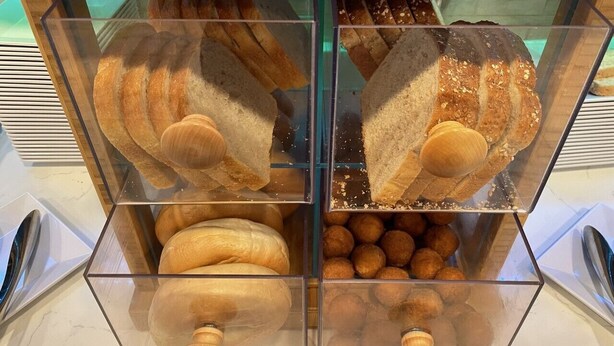 A bakery display case with various breads and pastries. - Hyatt Place Tulsa Downtown (Tulsa)