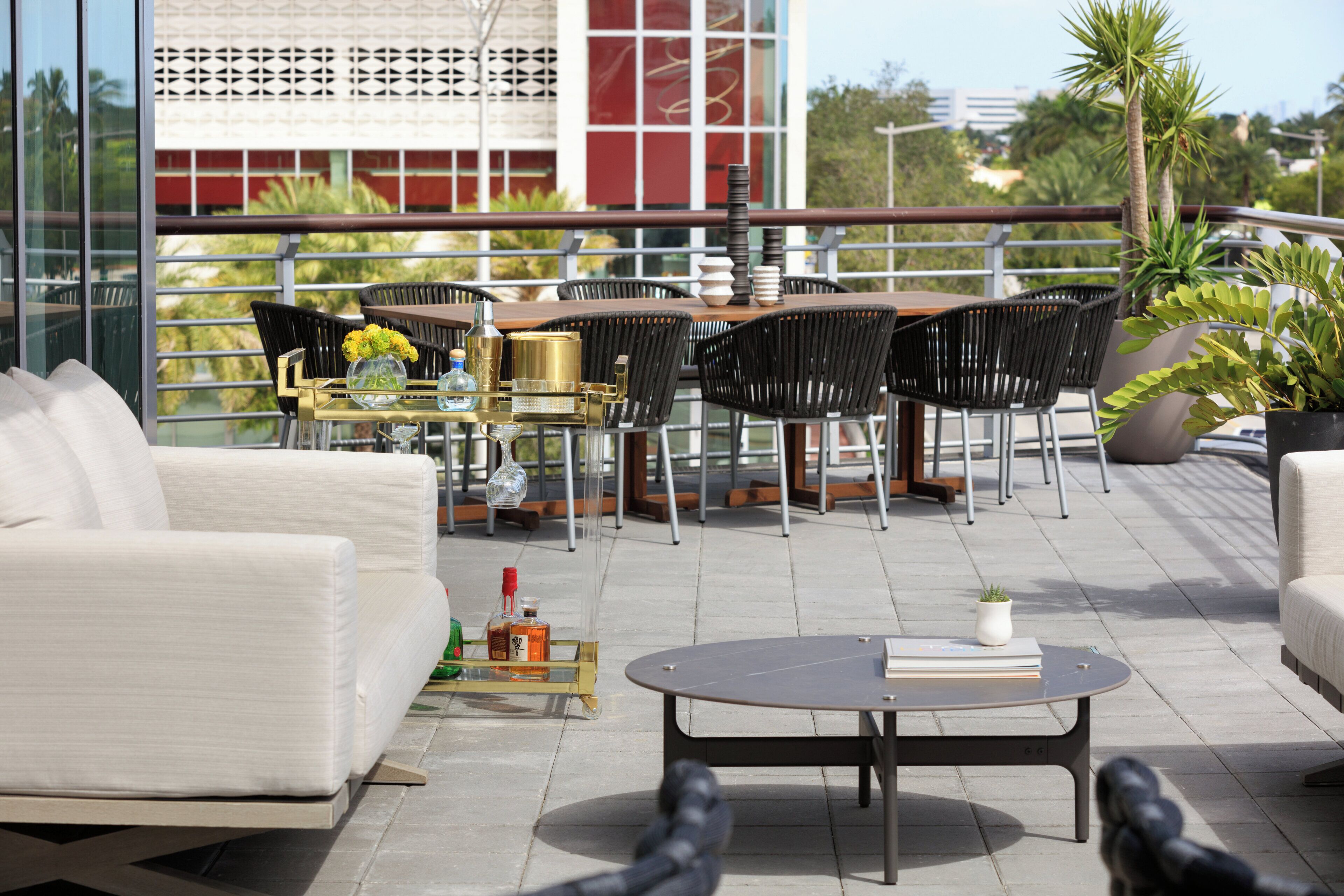 An outdoor seating area with a table, chairs, and a sofa.