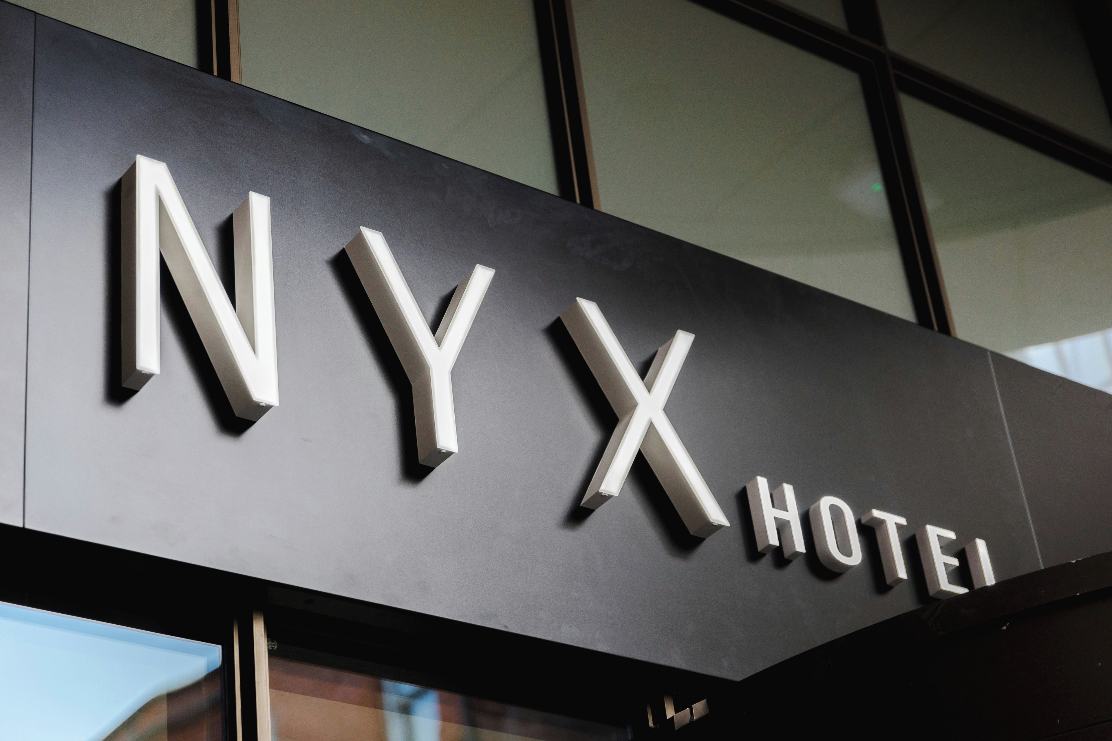 A sign for NYX Hotel with a modern design.