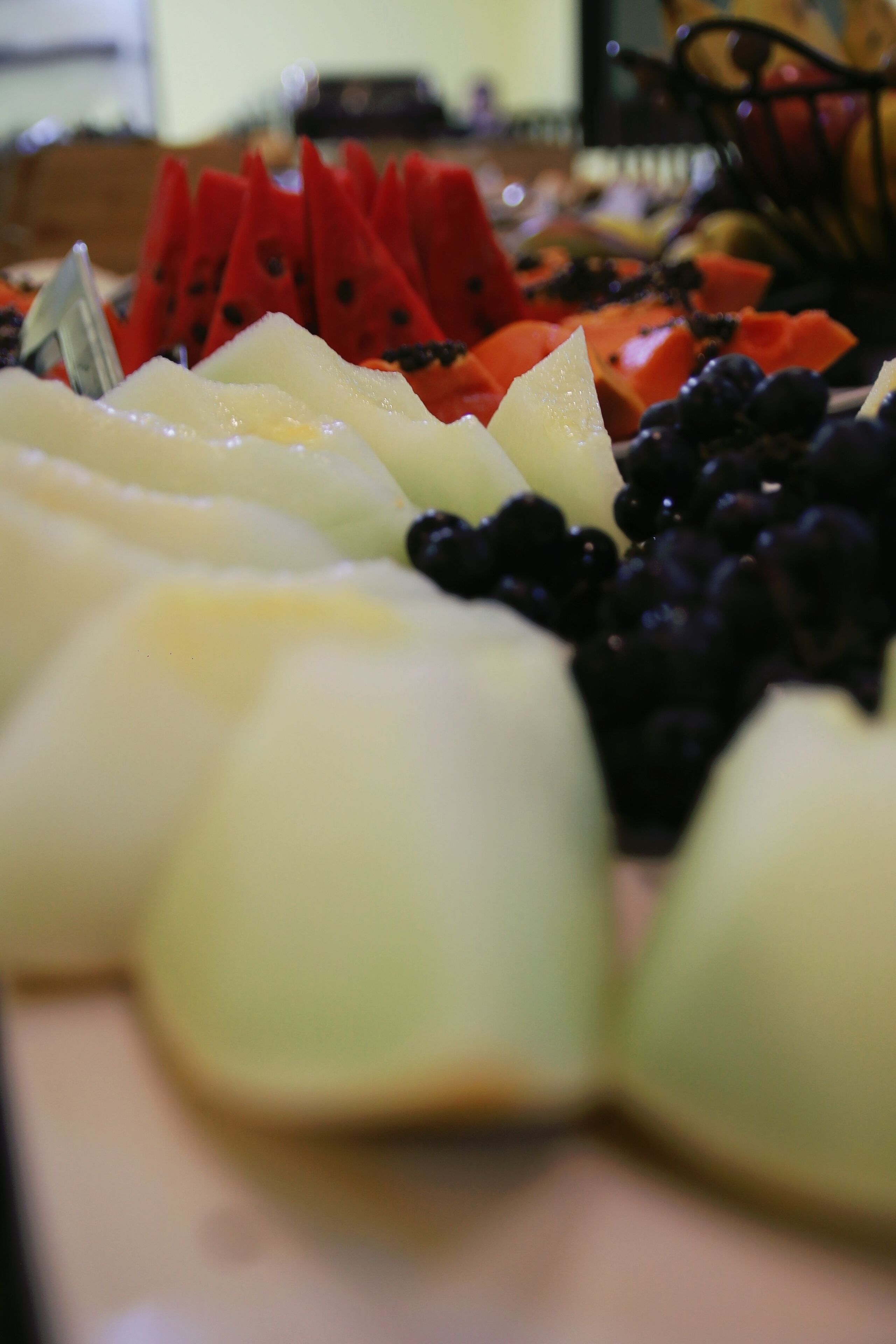 A close-up of a fruit platter with various fruits including watermelon, apples, and berries.