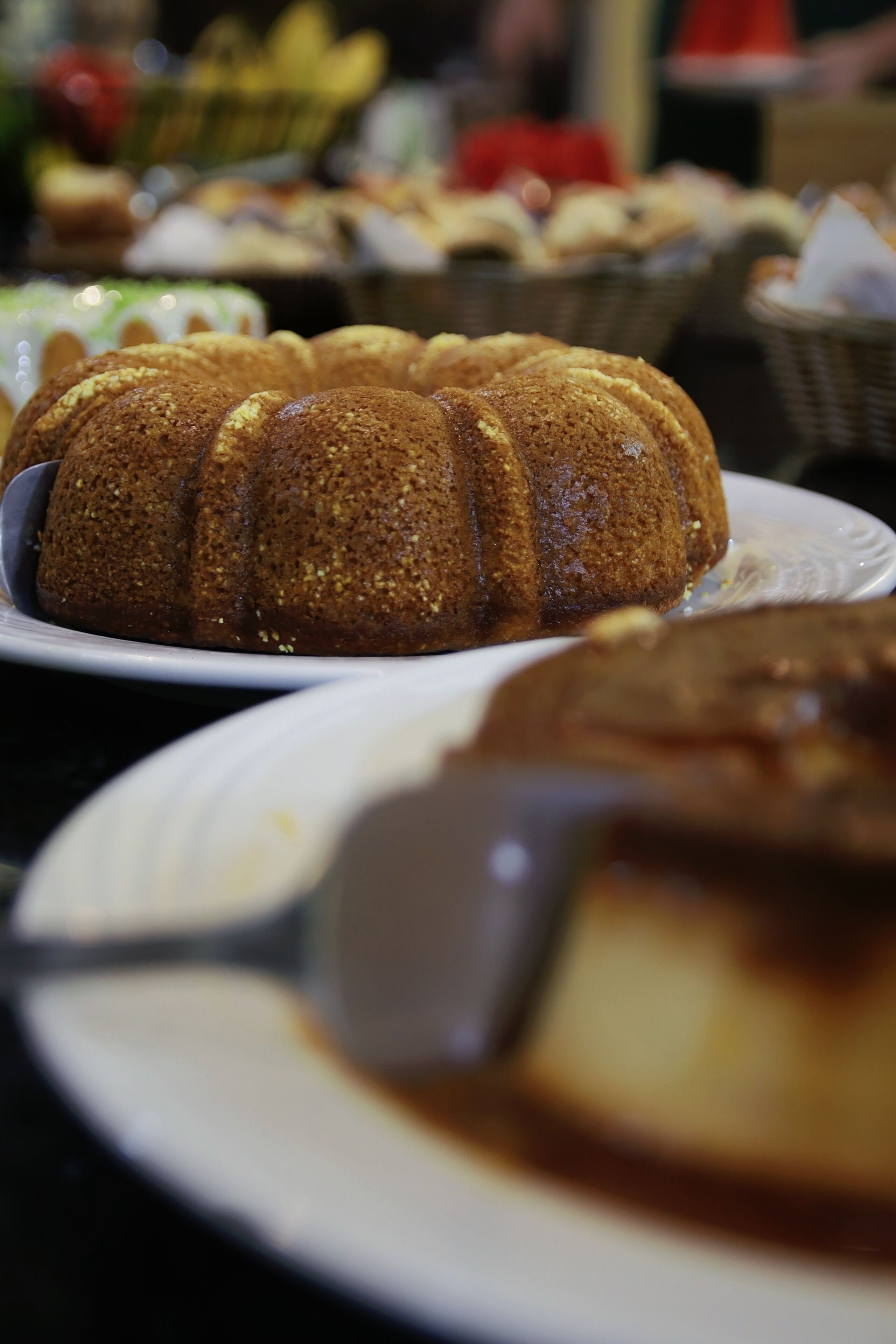 A cake on a plate with a spoon.