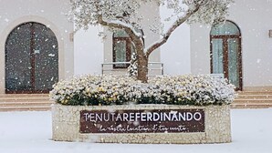 A snow-covered building with a sign reading "TENUTAREFERDINANDO." - Tenuta Re Ferdinando (Santa Maria Capua Vetere)