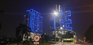 A nighttime view of two illuminated high-rise buildings with a speed limit sign of 30 km/h. - MLH Deluxe Studio Suites @ Landmark Residence (Cheras)