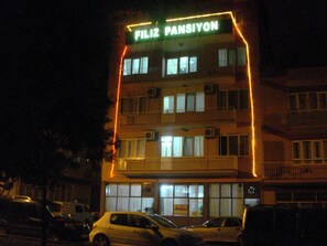 A multi-story building with illuminated signage reading "FILIZ PANSIYON." - Filiz Pansiyon (Denizli)