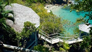 A coastal resort with a wooden staircase leading to a beach. - Smuggler's Nest - Exotic & romantic villa 2 bedroom Tropical Retreat (Cap Estate)