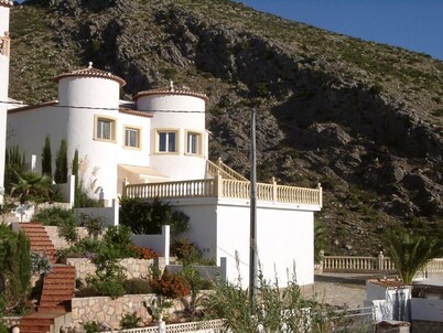 At the edge of a nature reserve, detached villa with pool &  view of sea