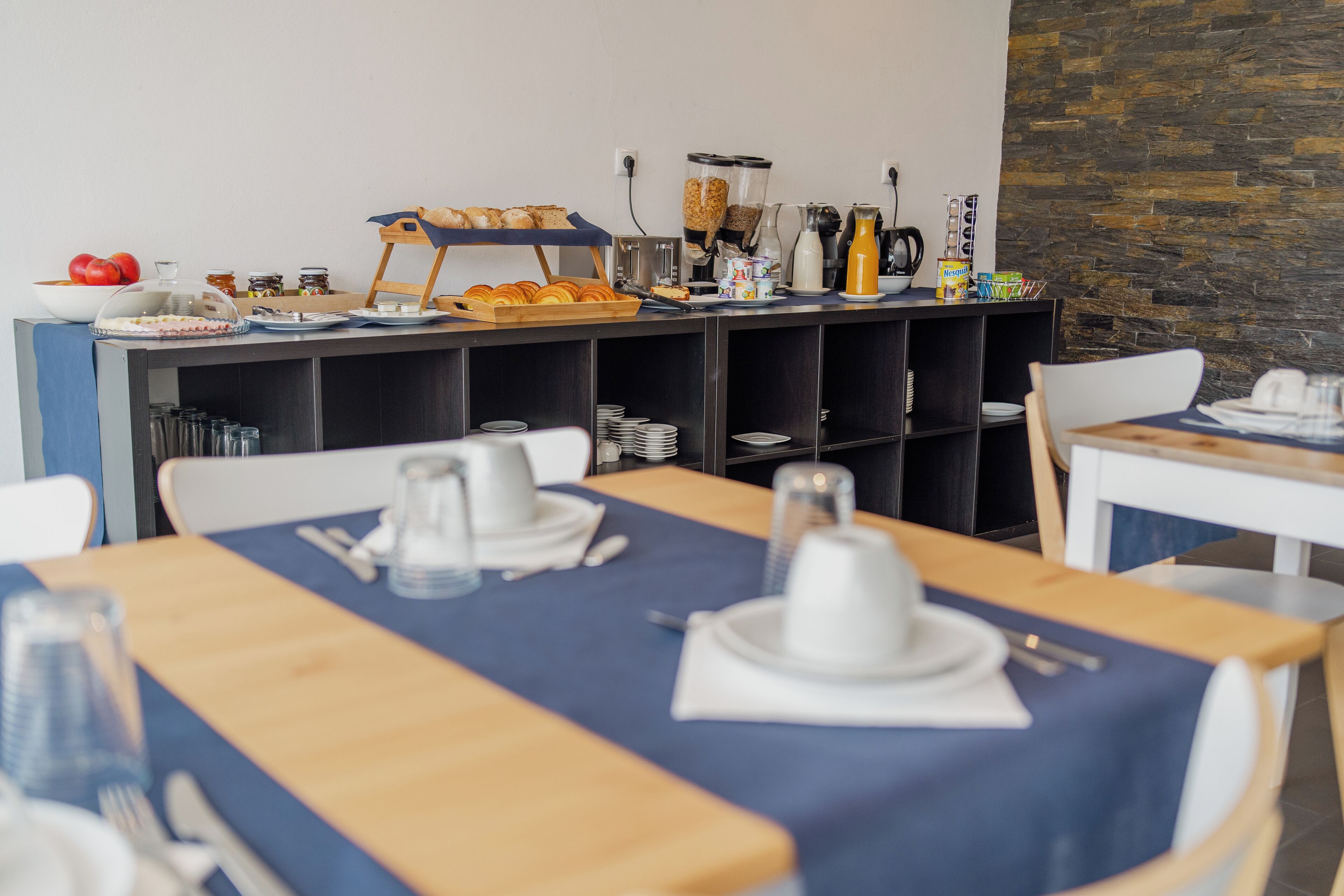A breakfast buffet setup with various food items and beverages.