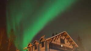 A house with a sloped roof and a visible chimney. - Abbey Archway Inn (Fairbanks)