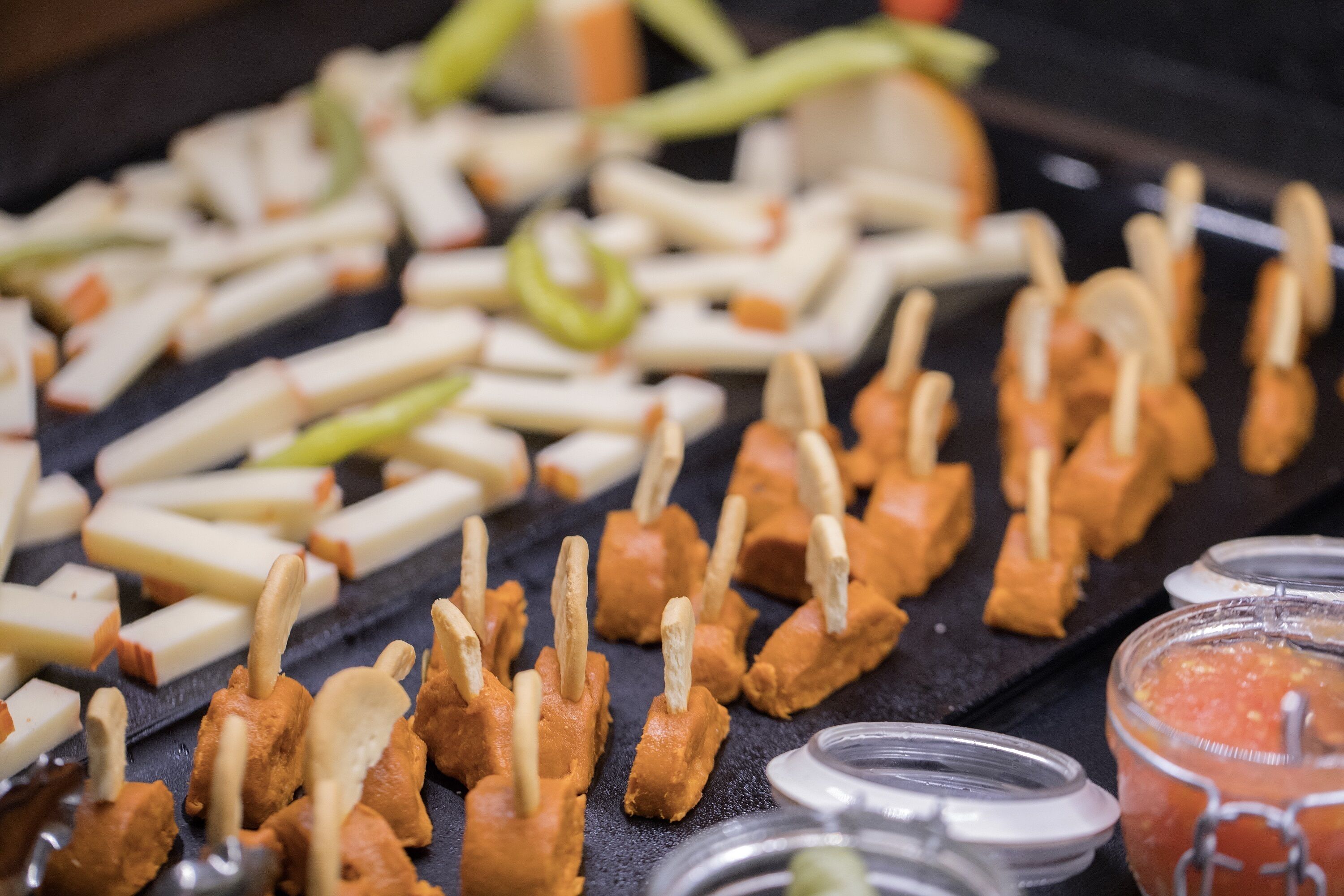 A variety of food items, including skewered meat and vegetables, arranged on a grill.