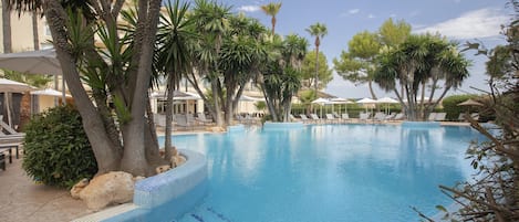 Piscine couverte, piscine extérieure, parasols de plage, chaises longues