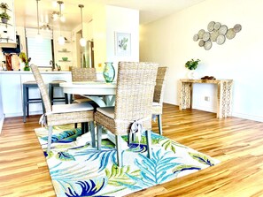 Enjoy meals in this dining area with a dining table and wicker chairs.