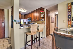 Enjoy casual dining and socializing in this well-equipped kitchen with a central island and dining table.