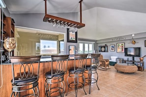 Enjoy a spacious kitchen and living area with a central bar, comfortable seating, and a sink.