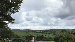 A gravel path leading to a gate with a fence and greenery on either side. - Farmhouse in the Donegal Hills (Letterkenny)