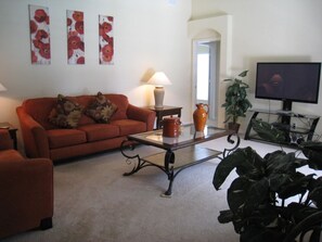 House | Living room | TV, books - Stunning 4 bed Villa With South Facing Pool and spa With no Immediate Rear Neighbors - 309 (Clermont)