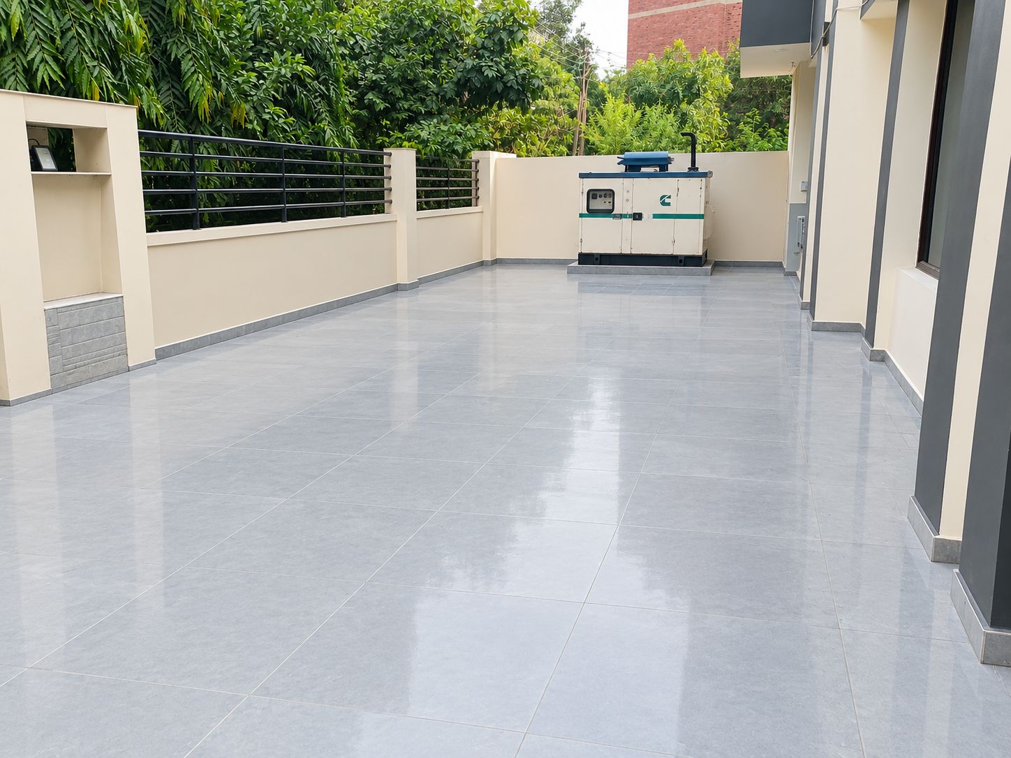 A spacious, modern outdoor area with a flat, tiled floor and a water dispenser.