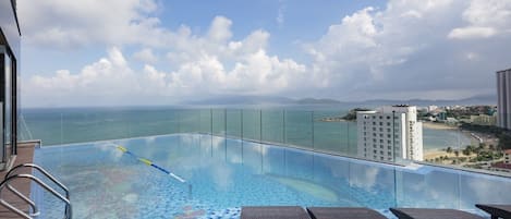Outdoor pool, open 7:00 AM to 10:00 PM, pool umbrellas, sun loungers