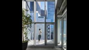 A modern building with large glass windows and a potted plant. - 9h nine hours Hamamatsucho (Tokyo)